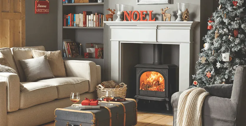 A stove and fireplace decorated with Christmas decorations