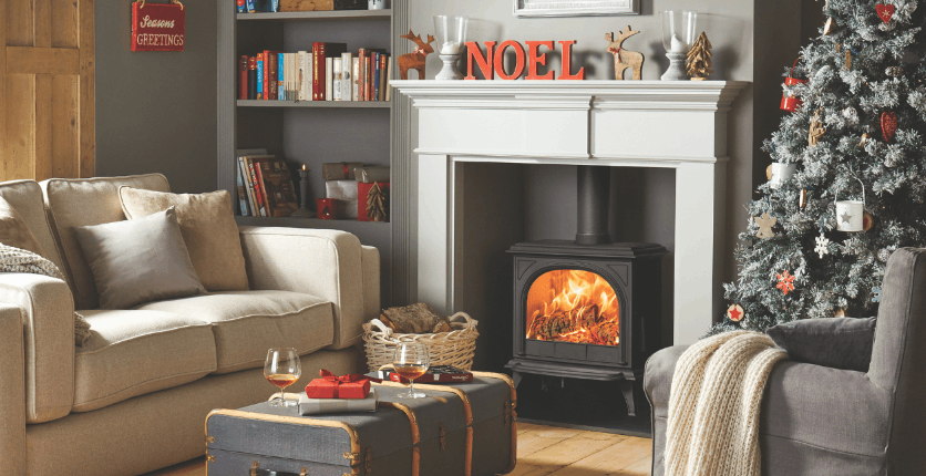 A stove and fireplace decorated with Christmas decorations